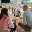 A Bootmine researcher and a participant looking at a prototype on a laptop