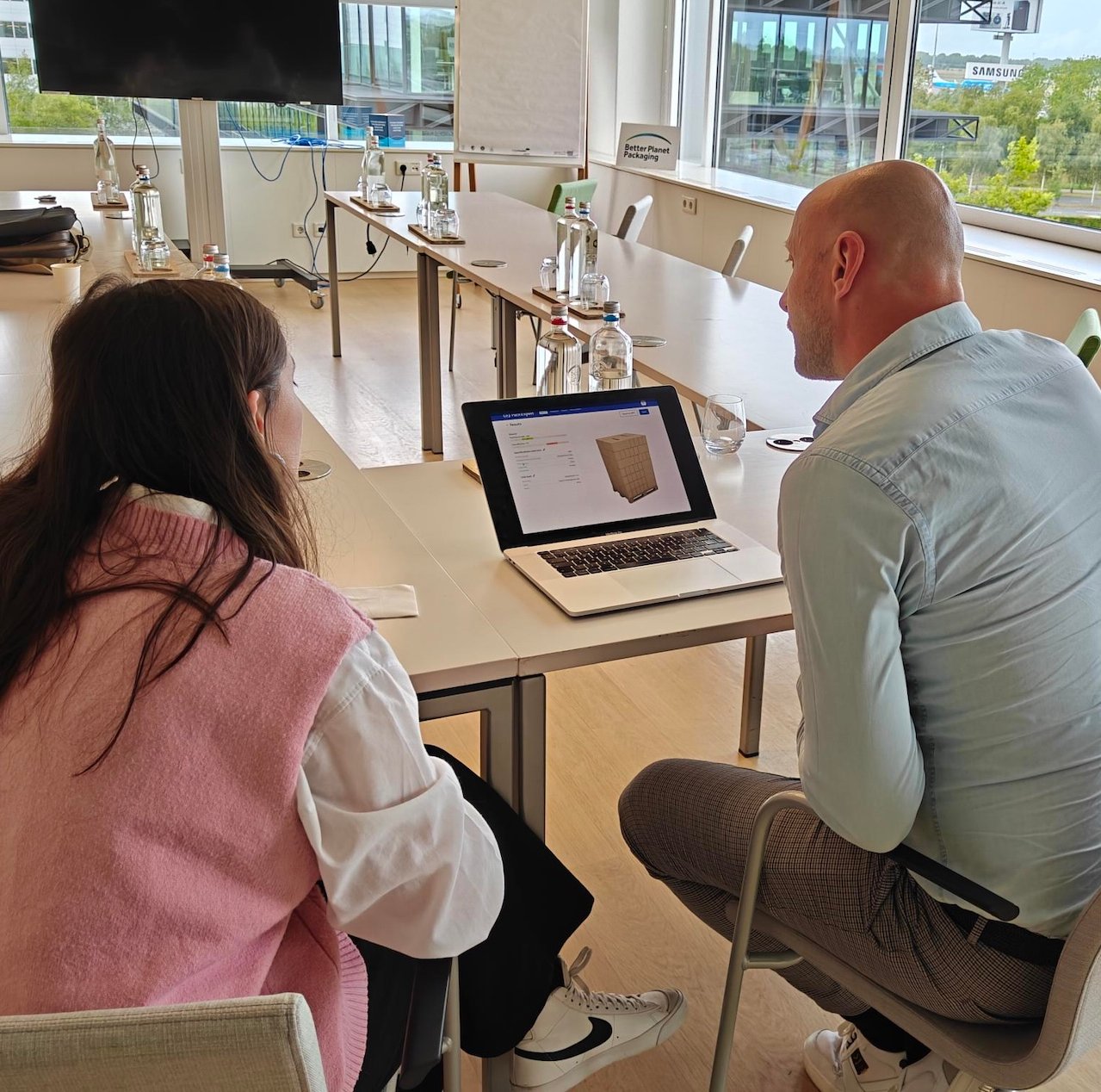 A Bootmine researcher and a participant looking at a prototype on a laptop during a usability test