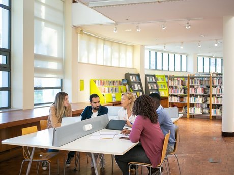 Students working together at a table in a library