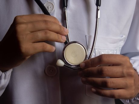 Doctor in a white coat holding a stethoscope